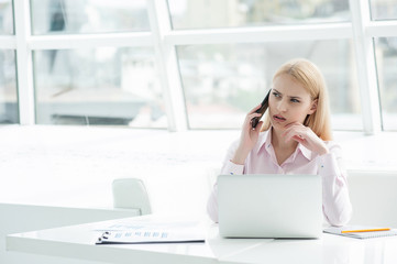 Young businesswoman sitting at office