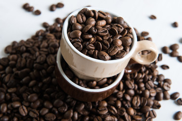 Two cups with coffee seeds