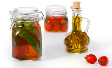Canned vegetables and olive oil with rosemary on white background.