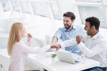 Young coworkers having brainstorming session in modern office