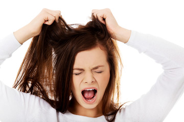 Young angry woman pulling her hair