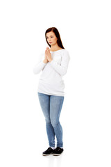 Beautiful young caucasian woman praying