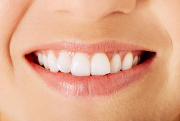 Healthy woman teeth and smile. Isolated over white.