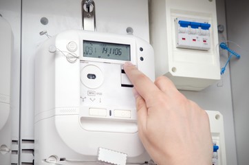 Electric energy meter. Electrical technician servicing unit - obrazy, fototapety, plakaty