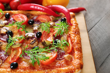 Rectangle delicious pizza and vegetables on the table, close-up