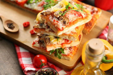 Pieces of delicious pizza on the table, close-up