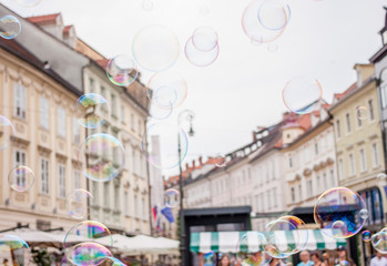 Soap bubbles on background of old town