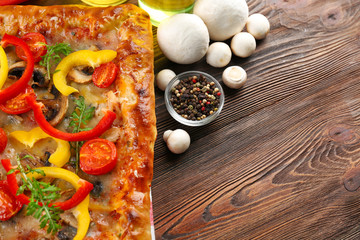 Freshly homemade pizza on wooden background