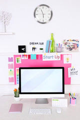 Stylish workplace with computer and interior decorations