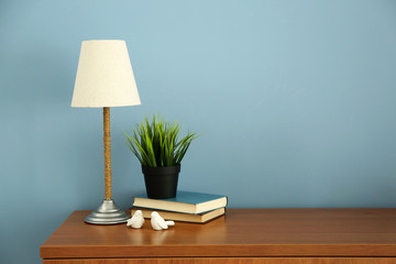 Design interior with lamp and plant on blue wall background