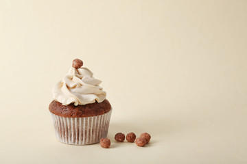 Tasty cupcake on color background