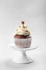 Tasty cupcake on light background
