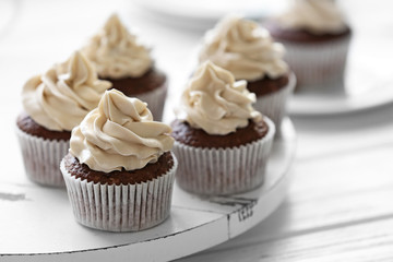 Tasty cupcakes on wooden table