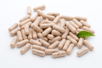 Ginkgo biloba capsule on the white background.