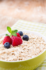 Oatmeal porridge with berries. Raspberries and blueberries.