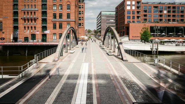 UHD Timelapse of pedestrians and tourists crossing Busanbruecke bridge in Hamburg HafenCity