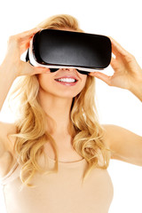 Happy woman wearing virtual reality goggles