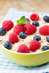 Oatmeal porridge with berries. Raspberries and blueberries.
