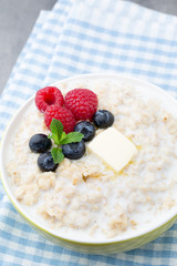Oatmeal porridge in bowl with berries raspberries and blackberri