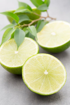 Juicy ripe lime an gray table.