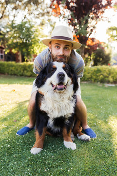 Man Hugging A Big Black Dog