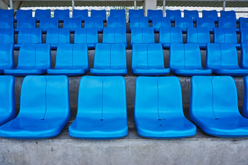 Naklejka premium Row of chairs in arena. Blue chairs in a sport stadium.