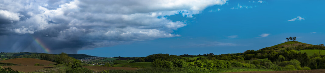 Fototapeta premium Clouds over tree topped Colmer's Hill, Dorset