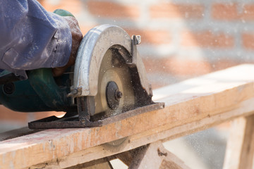 Carpenter using circular saw in loggers