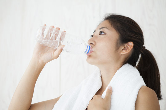Young women are drinking bottled water