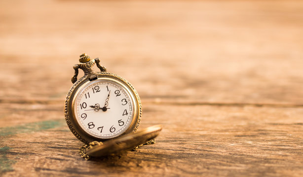 vintage pocket watch on grunge wood log