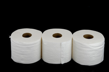 toilet paper rolls on black background