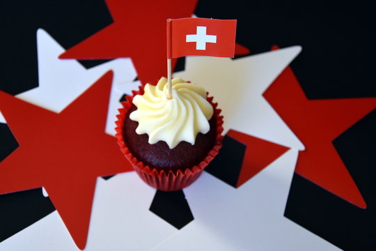 Swiss National Day cupcake with red and white cross swiss flag.