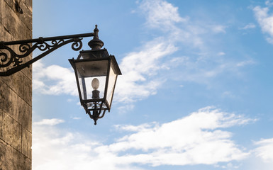 Fototapeta na wymiar Old street lamp in wrought iron.
