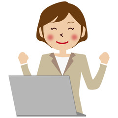 パソコンの前のベージュのスーツの女性　カッツポーズ 上半身