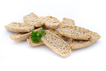 Dry flat bread crisps with herbs on a white background.