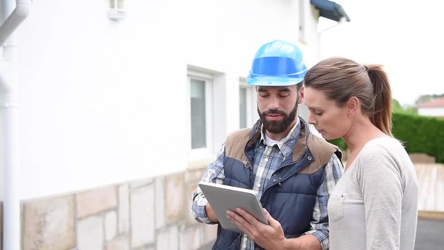 Technician with client showing what is being fixed