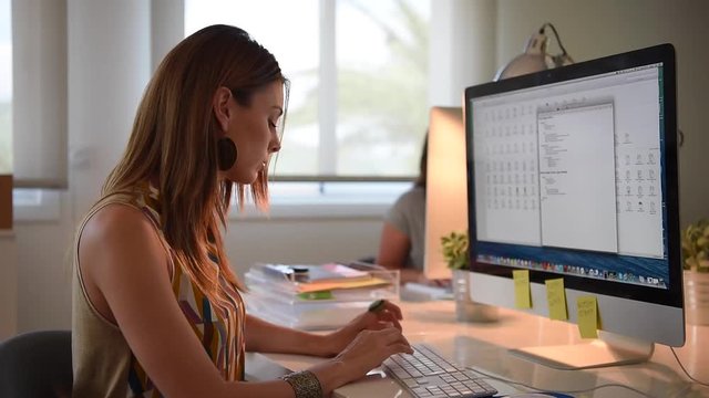 Businesswoman working in office on desktop