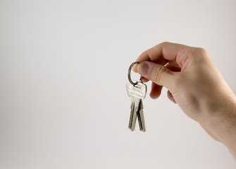 Hand with keys on a white background