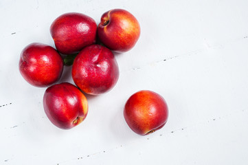 nectarines on white wooden table. Close up