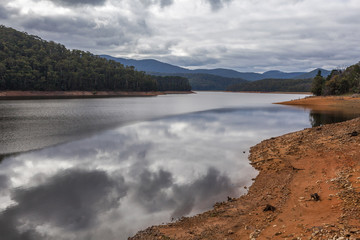 Maroondah reservoir park lake on cloduy day with cloud reflections in the water