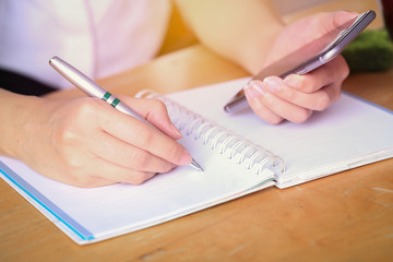 Business women writing and working on desk office.