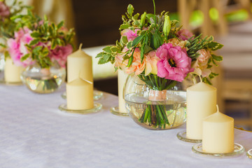Beautiful table set with candles and flowers for a festive event, party or wedding reception