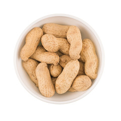 Round ceramic bowl of peanuts in shells. Top view.