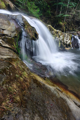Naklejka premium Waterfall in the mountains
