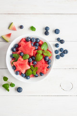 Naklejka na ściany i meble Summer fruit salad of watermelon and blueberries, top view, flat lay