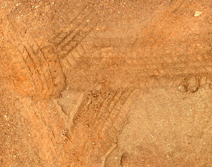 Tire tracks on the road gravel stone background