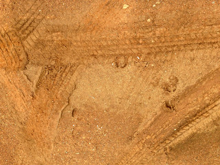 Tire tracks on the road gravel stone background