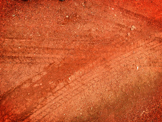 Tire tracks on the road gravel stone background