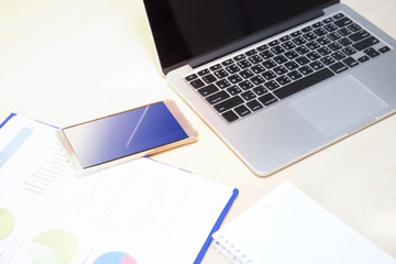 Photo on the desk with a phone and computer.