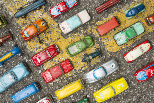 Collection of antique toy cars on asphalt background